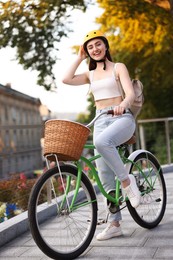 Photo of Woman in helmet riding bicycle on city street