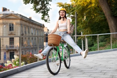 Photo of Woman in helmet riding bicycle on city street