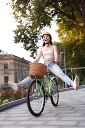 Photo of Woman in helmet riding bicycle on city street