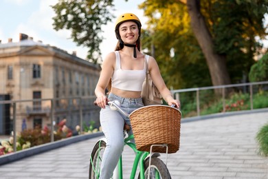 Photo of Woman in helmet riding bicycle on city street