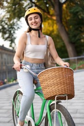 Photo of Woman in helmet riding bicycle on city street