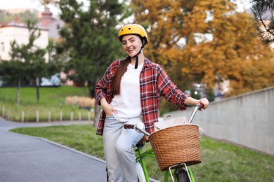 Photo of Woman wearing helmet with bicycle in park
