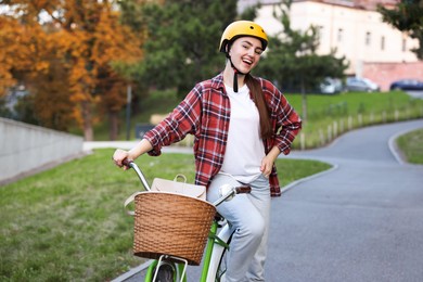 Photo of Woman wearing helmet with bicycle in park