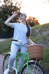 Photo of Happy woman riding bicycle on city street