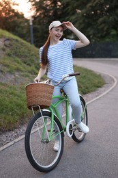 Photo of Happy woman riding bicycle on city street