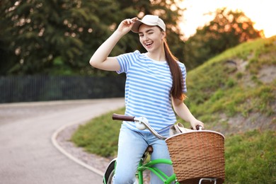 Photo of Happy woman riding bicycle on city street