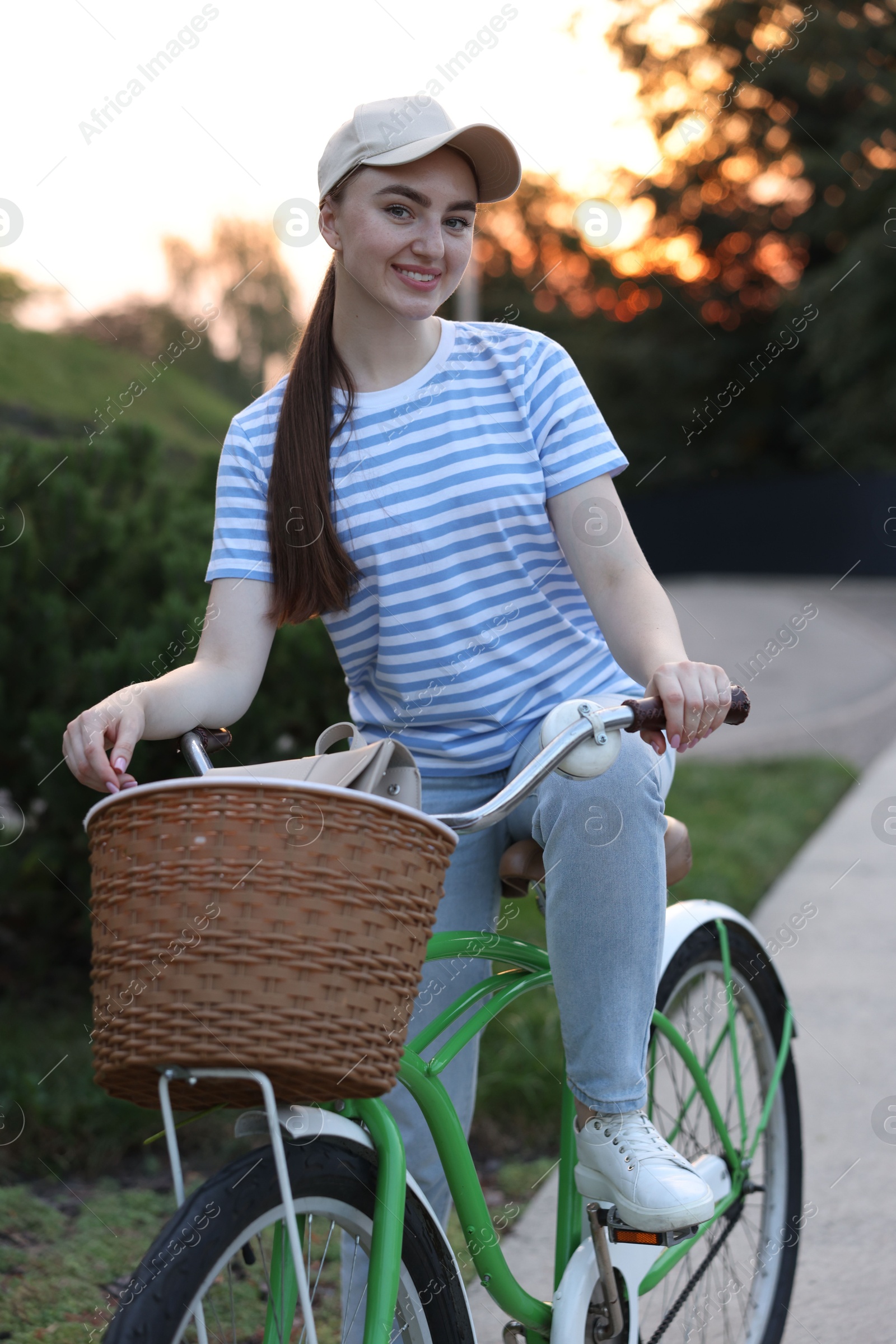 Photo of Happy woman riding bicycle on city street