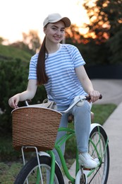 Photo of Happy woman riding bicycle on city street