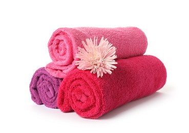Photo of Rolled fresh terry towels and flower isolated on white