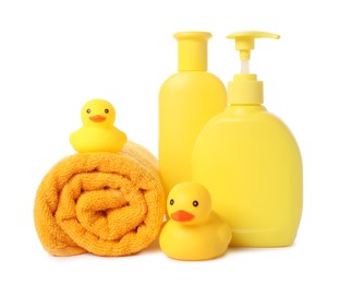 Photo of Rolled fresh terry towel, cosmetic products and rubber ducks isolated on white