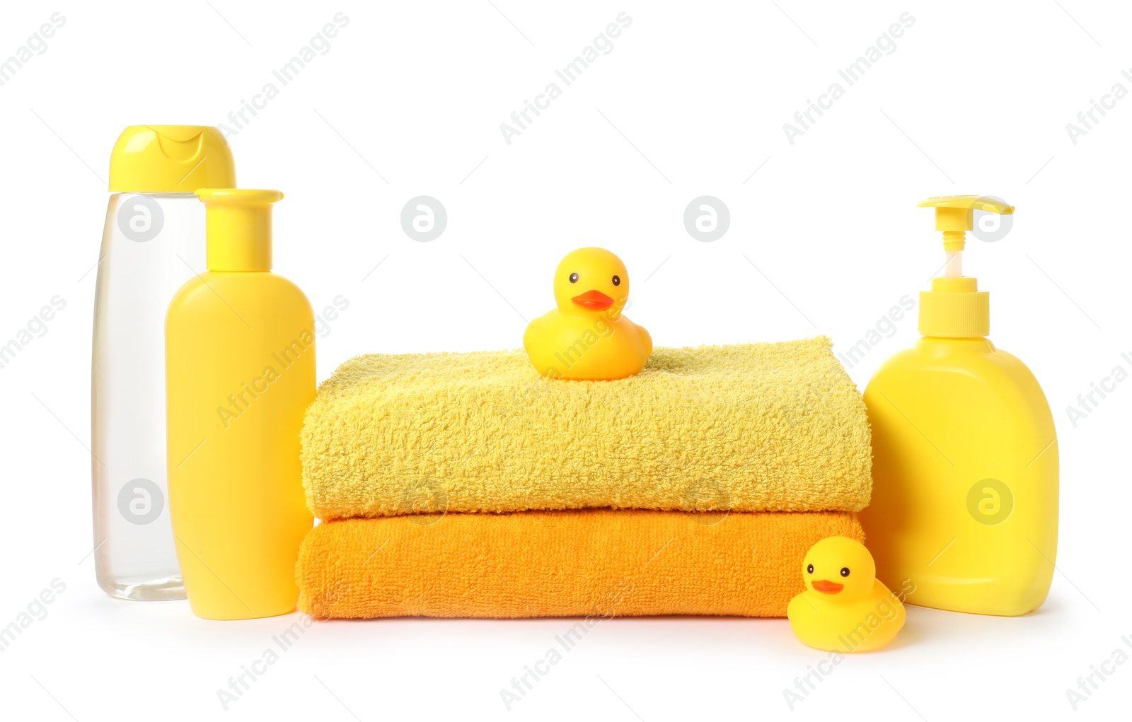Photo of Stack of fresh terry towels, cosmetic products and rubber ducks isolated on white