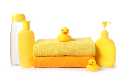 Photo of Stack of fresh terry towels, cosmetic products and rubber ducks isolated on white
