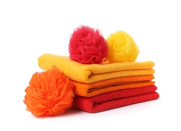 Photo of Stack of fresh terry towels and sponges isolated on white