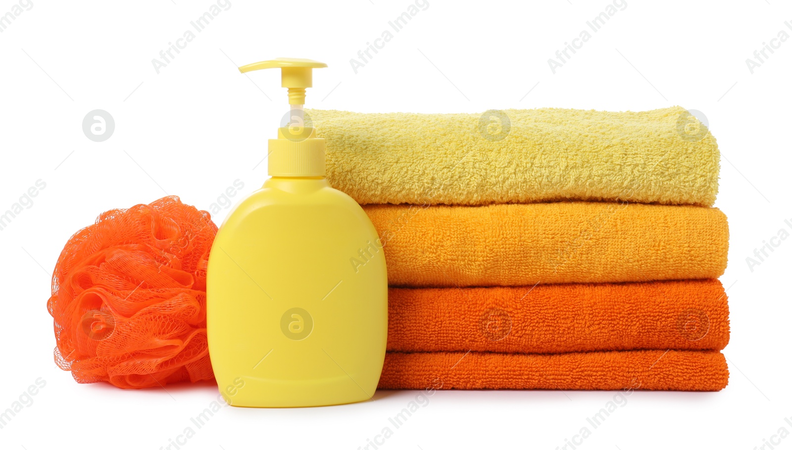 Photo of Stack of fresh terry towels, cosmetic product and sponge isolated on white