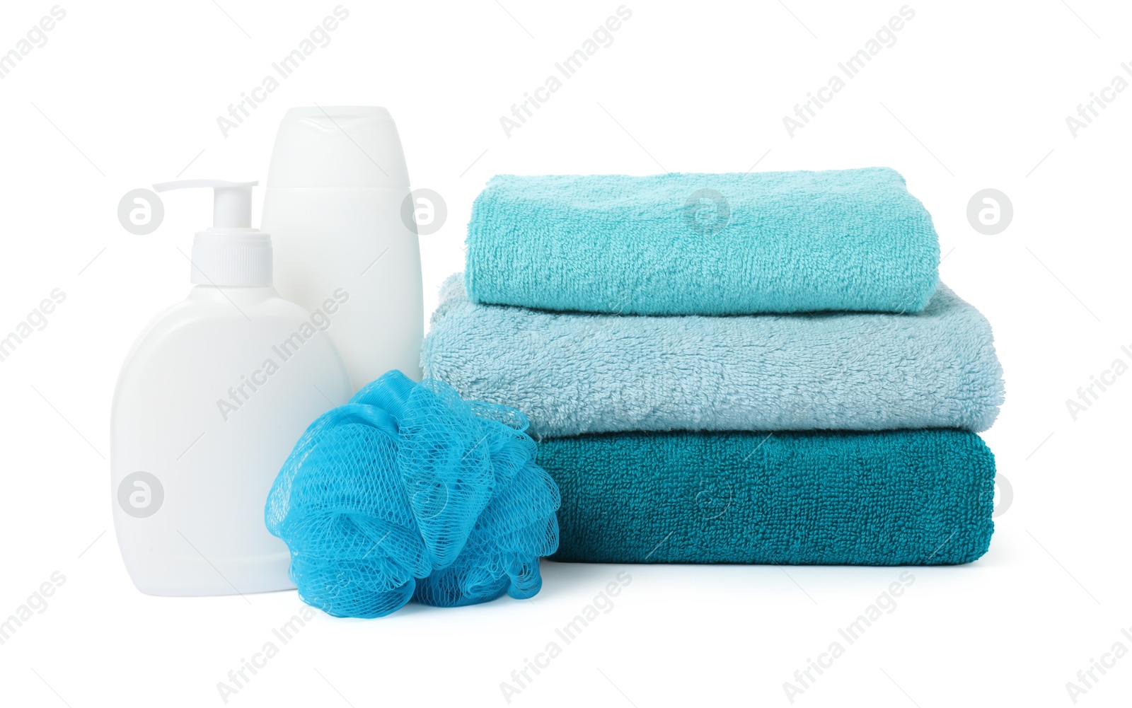 Photo of Stack of fresh terry towels, cosmetic products and sponge isolated on white