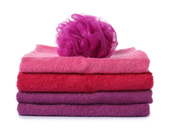 Photo of Stack of fresh terry towels and sponge isolated on white