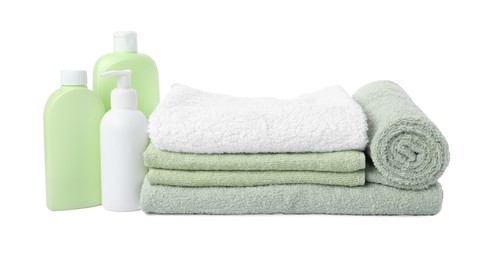 Photo of Fresh terry towels and cosmetic products isolated on white