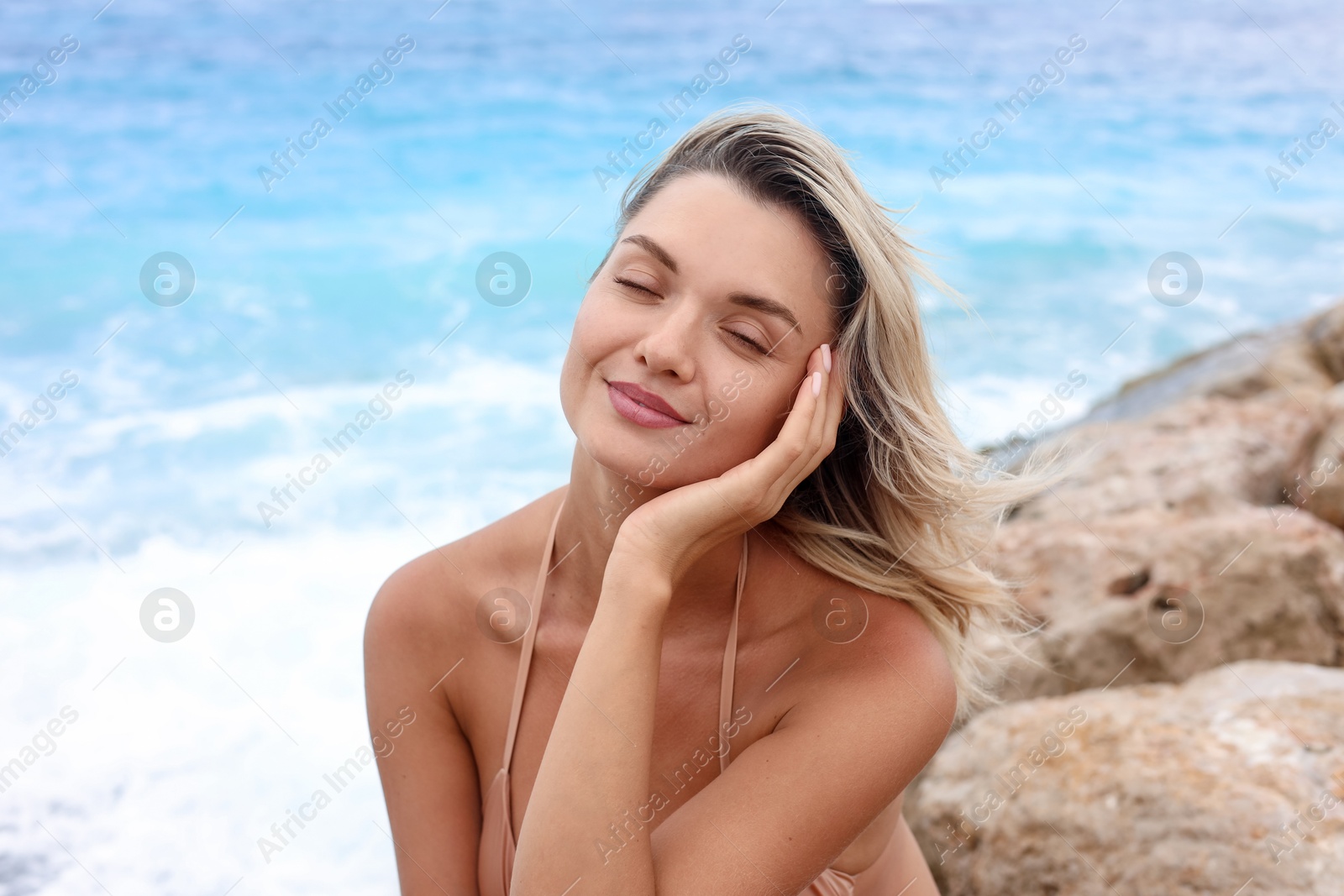 Photo of Beautiful woman wearing stylish bikini on beach