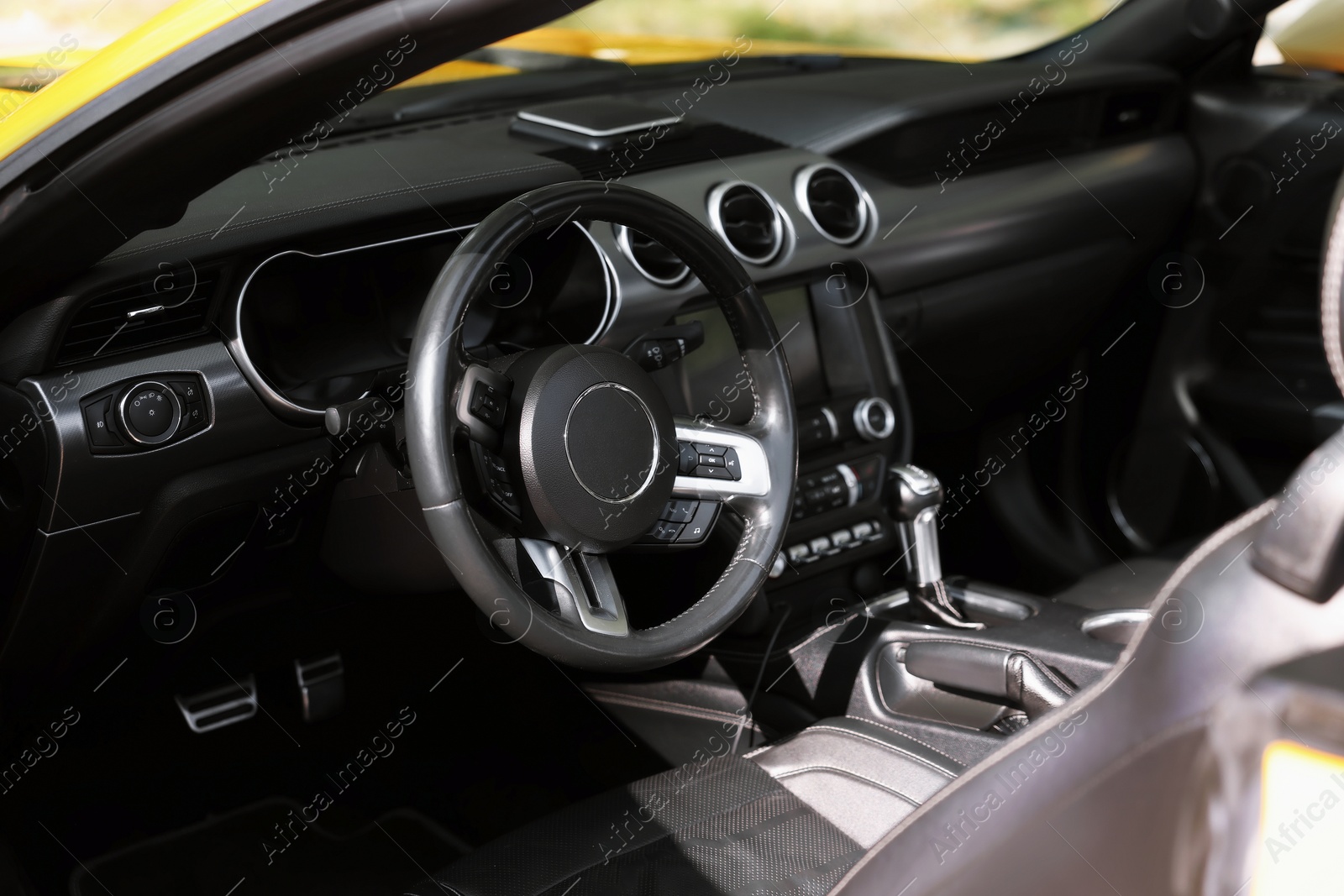 Photo of Interior of modern cabriolet parked outdoors, closeup
