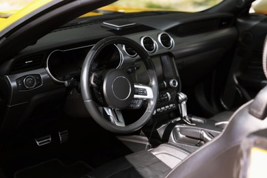 Photo of Interior of modern cabriolet parked outdoors, closeup