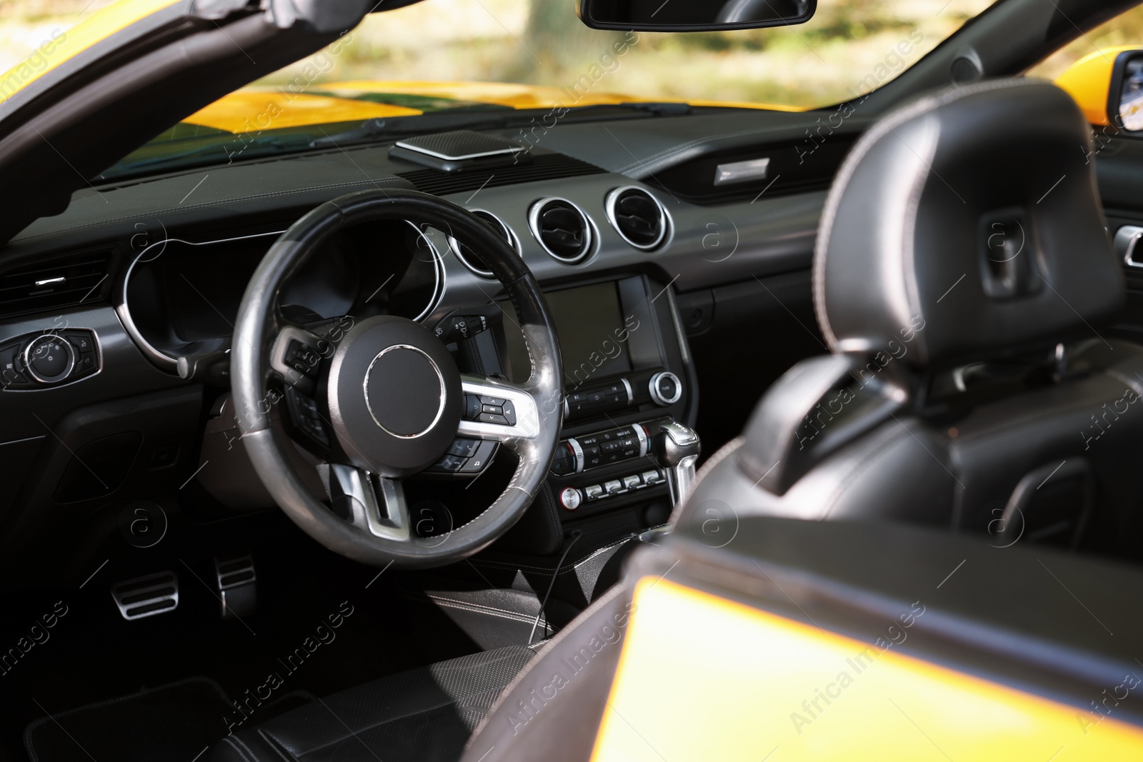 Photo of Interior of modern cabriolet parked outdoors, closeup