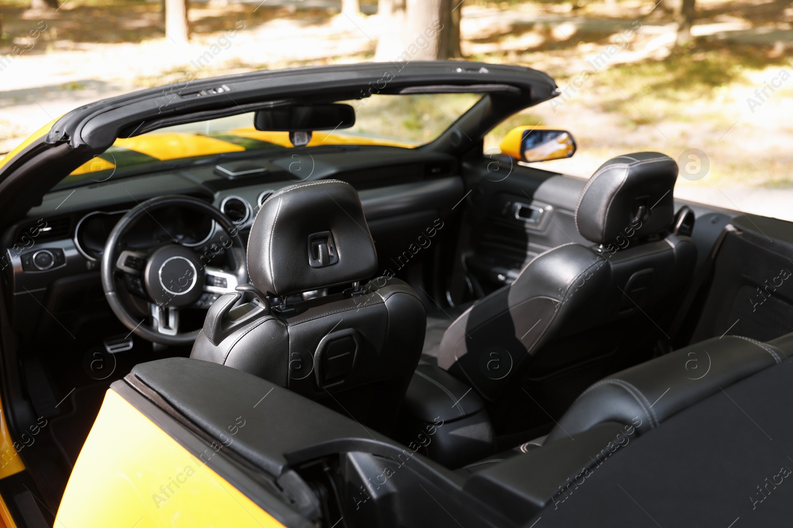 Photo of Interior of modern cabriolet parked outdoors, closeup