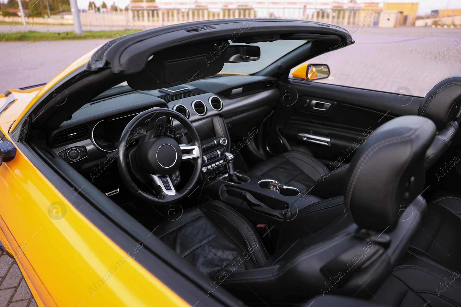 Photo of Interior of modern cabriolet parked outdoors, closeup