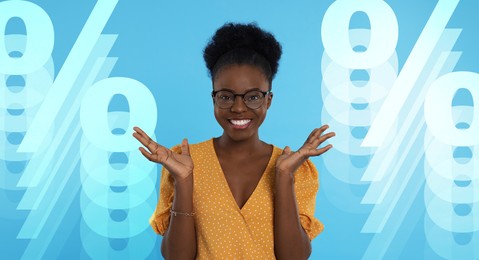 Image of Amused woman and percent signs on light blue background