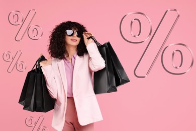Image of Happy woman with shopping bags and percent signs against pink background