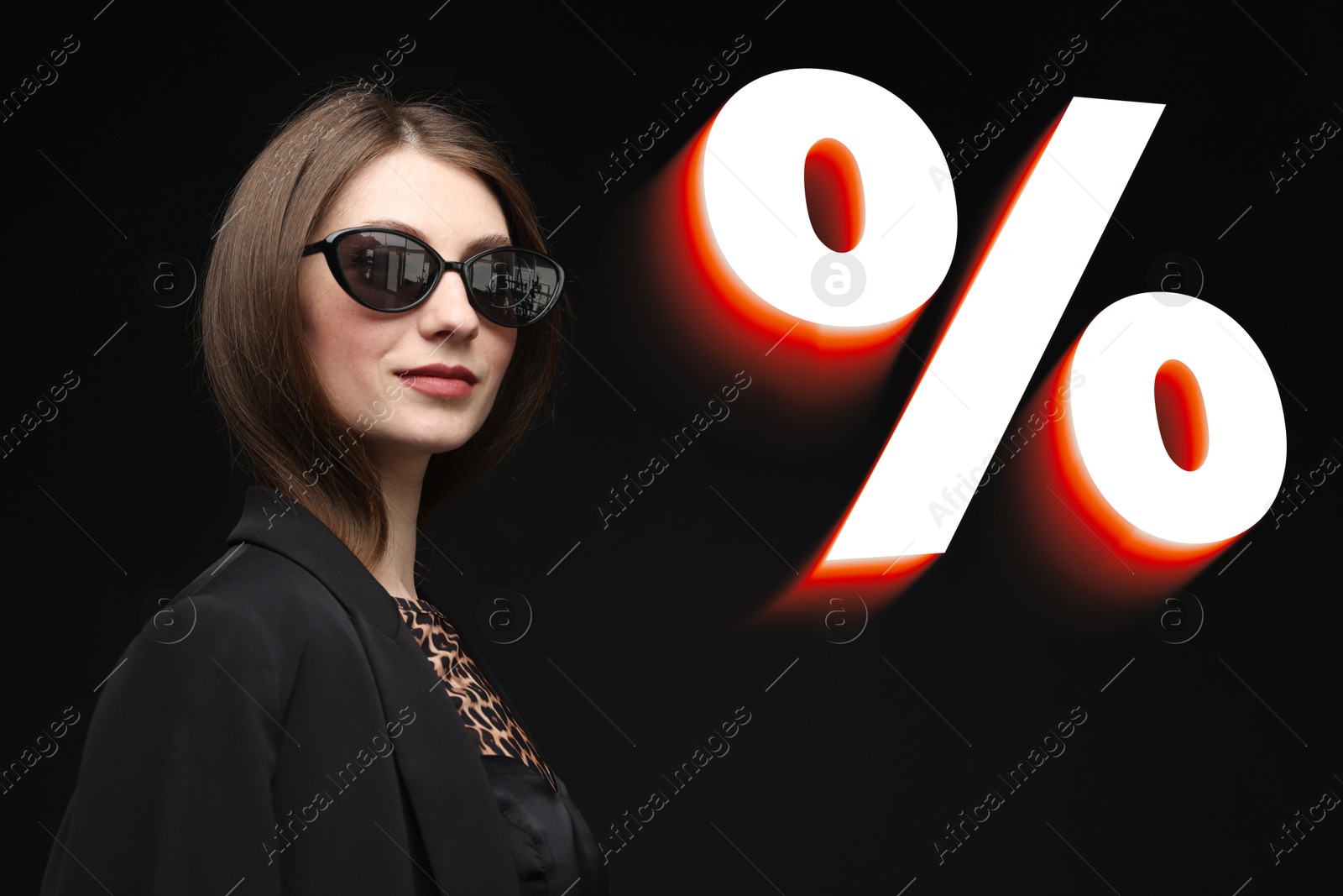 Image of Fashionable woman and percent sign against black background