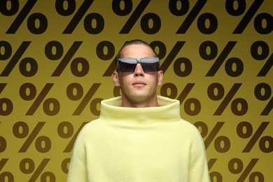 Image of Fashionable man against dark yellow background with percent signs