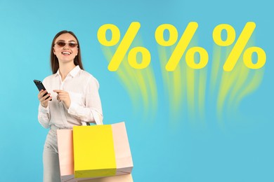 Image of Happy woman with shopping bags and mobile phone against light blue background. Percent signs near her