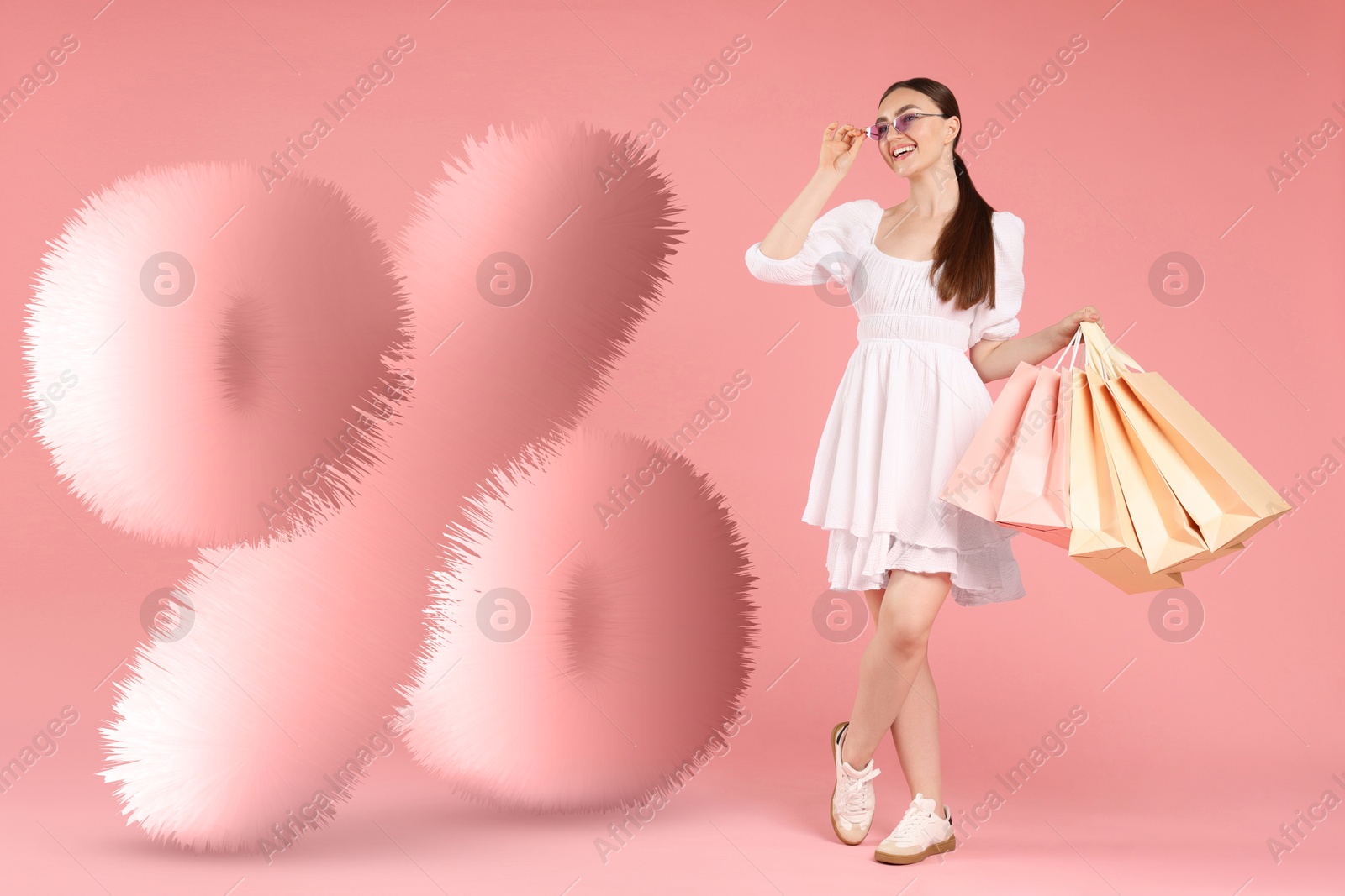Image of Happy woman and fluffy percent sign against pink background