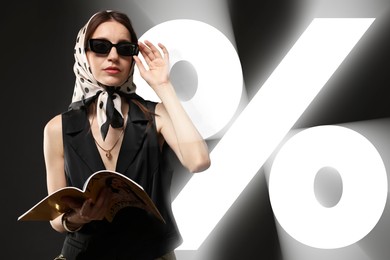 Image of Fashionable woman with magazine and percent sign against black background