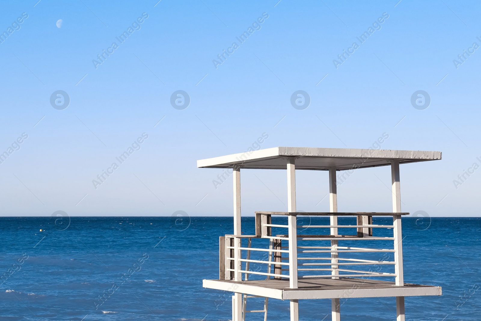 Photo of Beautiful view of wavy sea and lifeguard tower on sunny day