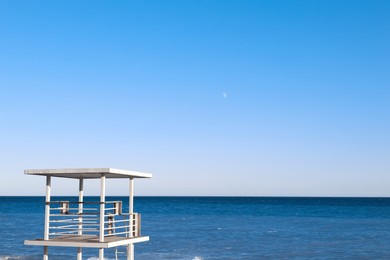 Photo of Beautiful view of wavy sea and lifeguard tower on sunny day