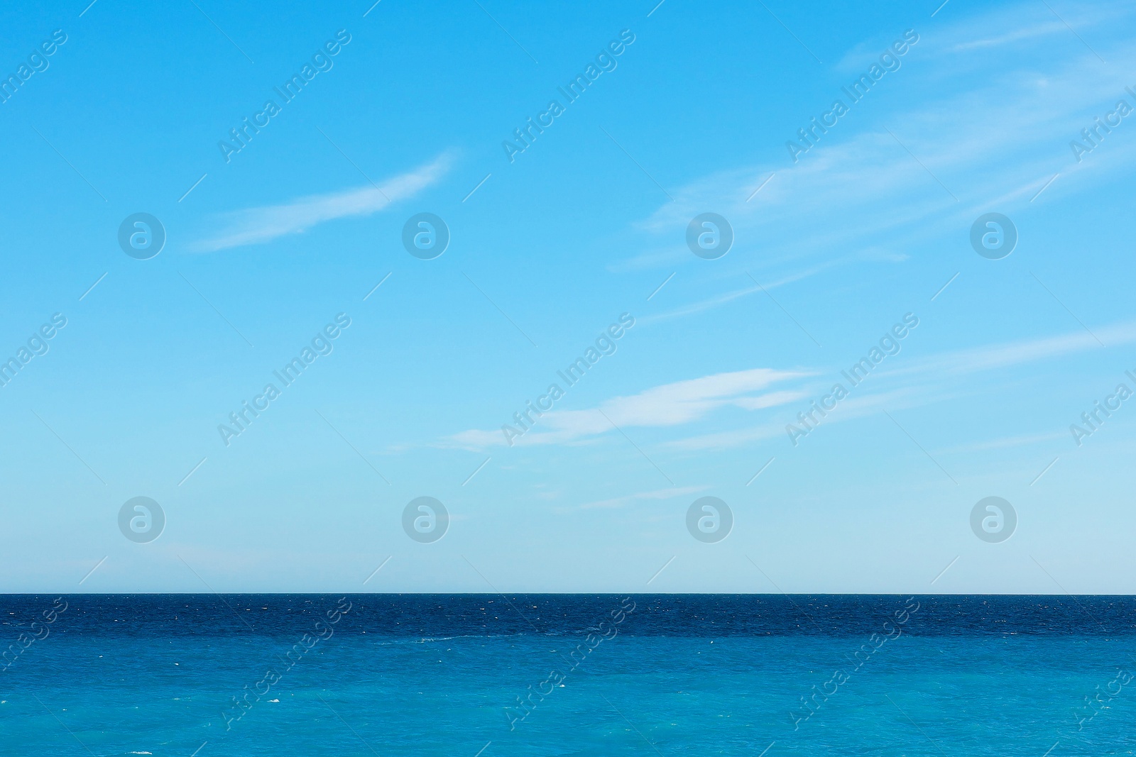Beautiful view of wavy sea and people parasailing on sunny day Photo of Beautiful view of wavy sea and people parasailing on sunny day