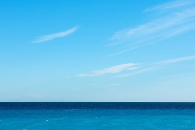 Photo of Beautiful view of wavy sea and people parasailing on sunny day