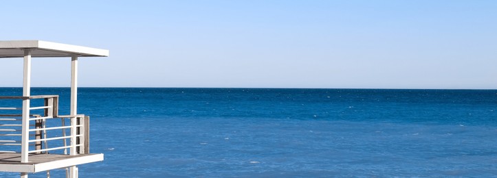Photo of Beautiful view of wavy sea and lifeguard tower on sunny day