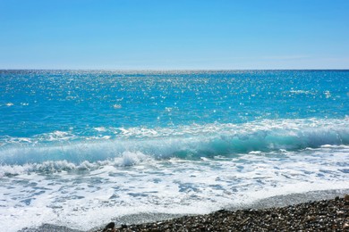 Photo of Beautiful view of wavy sea and pebbles on beach