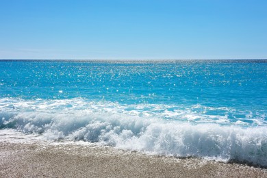 Photo of Beautiful view of wavy sea and pebbles on beach