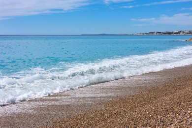 Photo of Beautiful view of wavy sea and pebbles on beach