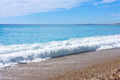 Photo of Beautiful view of wavy sea and pebbles on beach