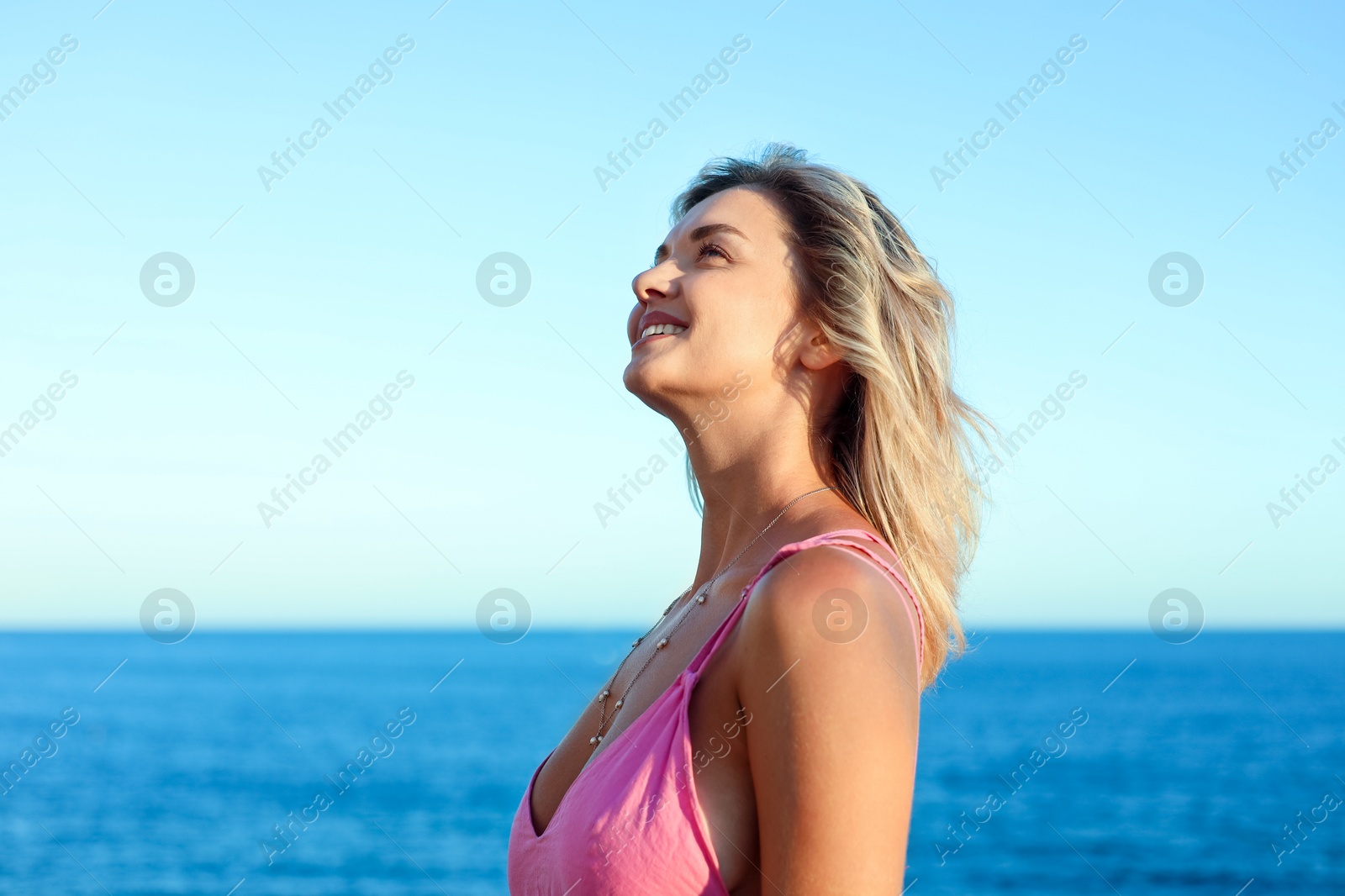 Photo of Happy woman near sea on summer day
