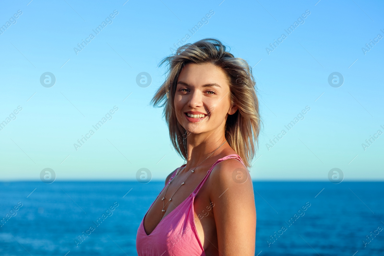 Photo of Happy woman near sea on summer day