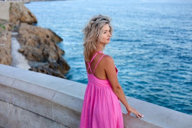 Photo of Beautiful woman near sea on summer day
