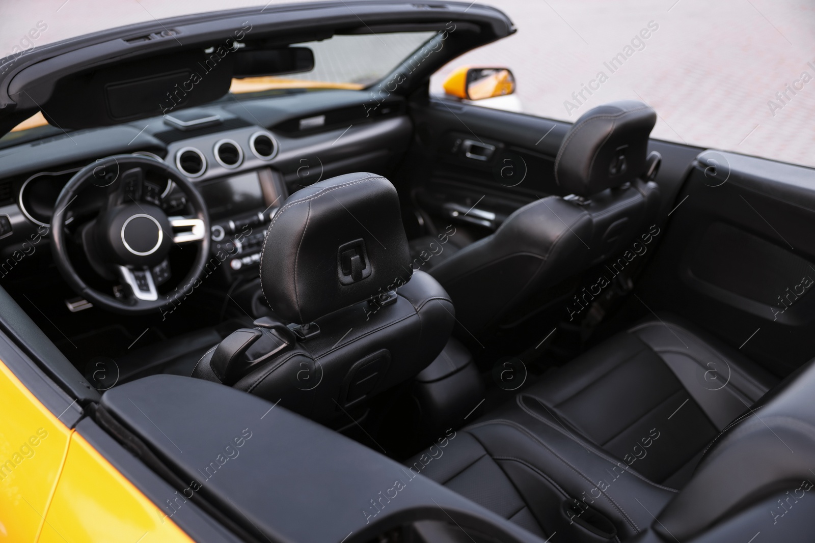 Photo of Interior of modern cabriolet parked outdoors, closeup