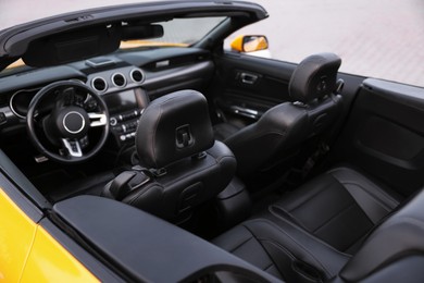 Photo of Interior of modern cabriolet parked outdoors, closeup