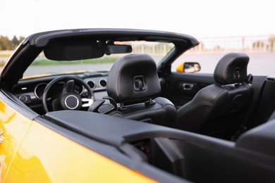 Photo of Interior of modern cabriolet parked outdoors, closeup