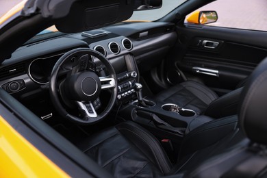 Photo of Interior of modern cabriolet parked outdoors, closeup